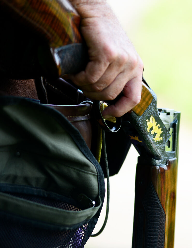 A competitor holds his open shotgun